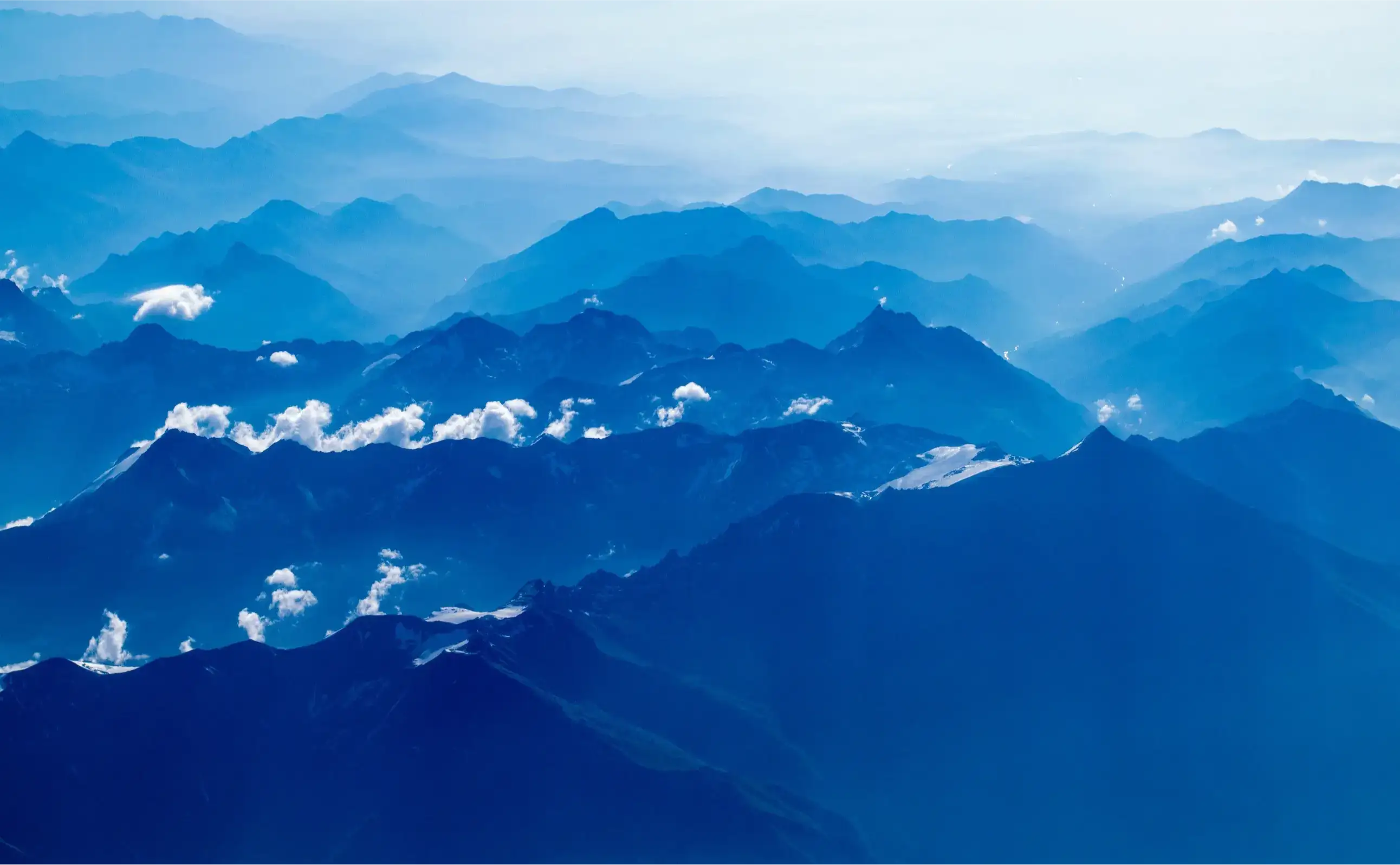 Aerial photography of mountain under clear blue sky