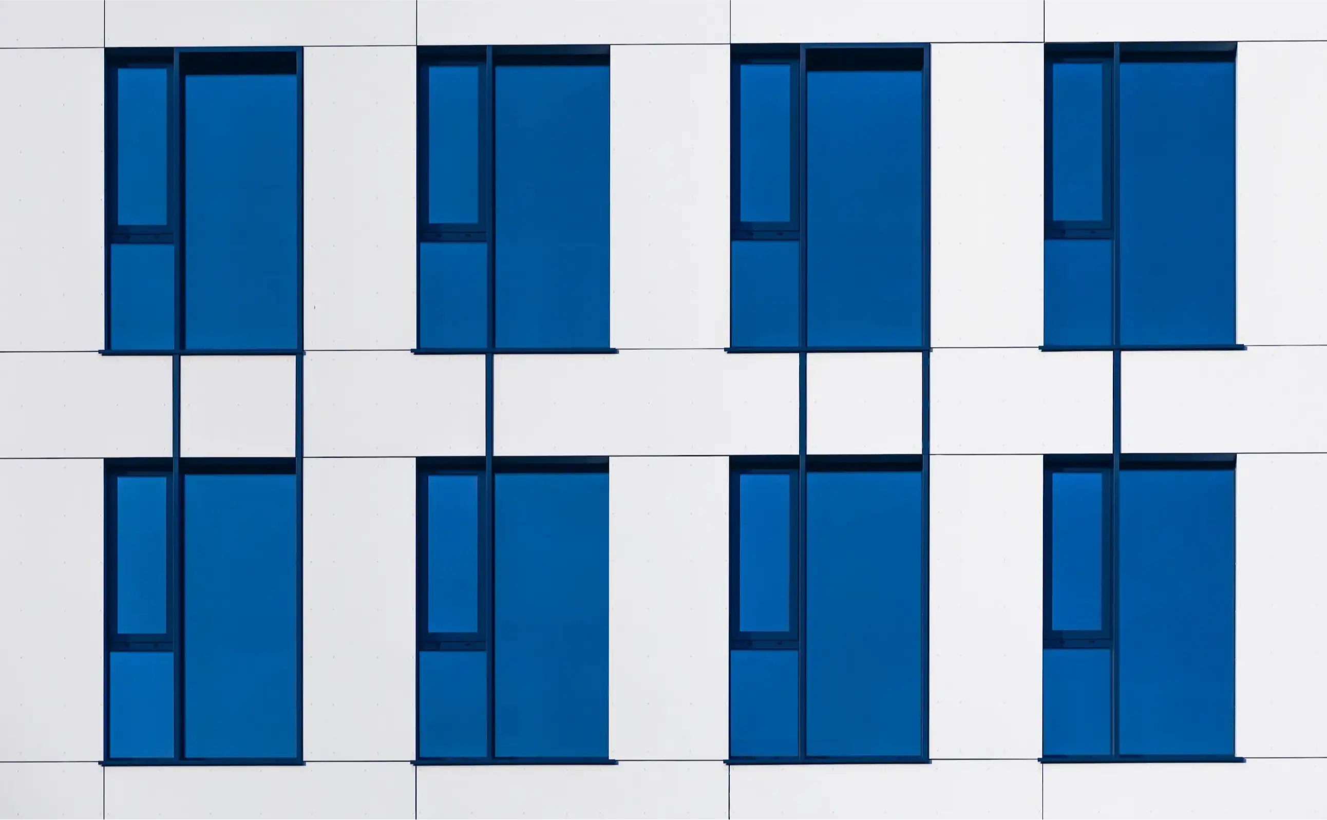 A white and blue building with blue windows